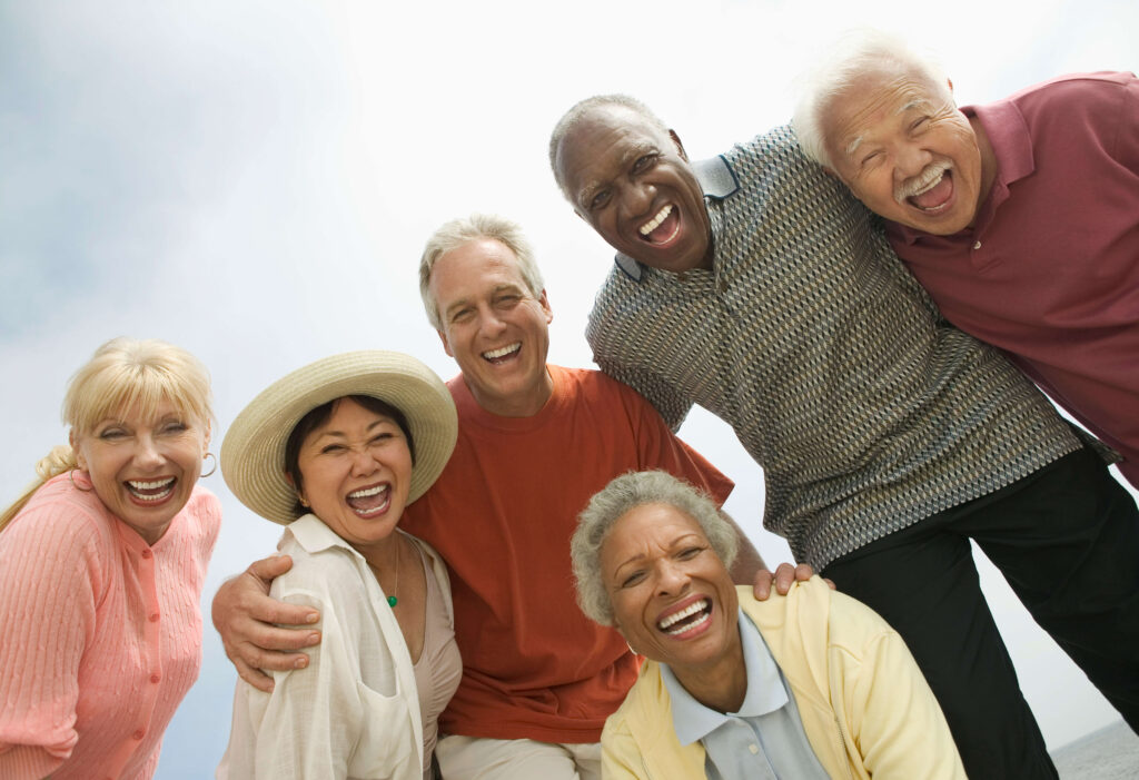 6.Group of 6 Seniors Smiling Laughing Embracing Outside 3 male female